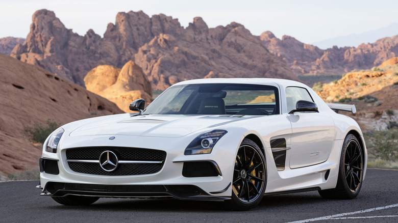 White Mercedes-Benz SLS AMG supercar on an open road