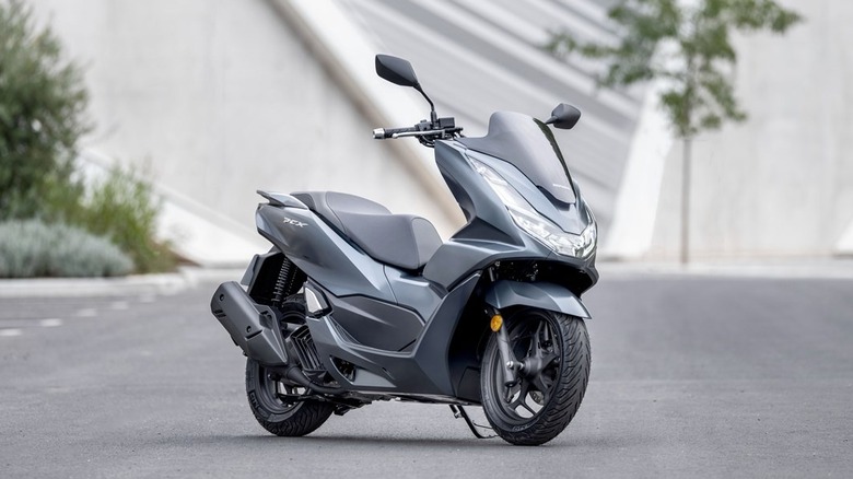 grey Honda PCX125 in parking lot