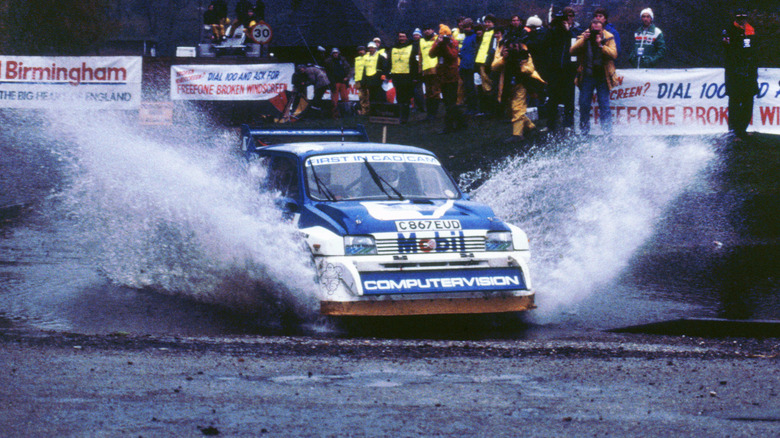 MG Metro 6R4 rally car driving through puddle of water