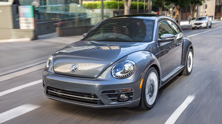 Blue VW Beetle driving on city street