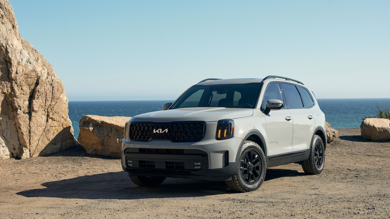 Kia Telluride front 3/4 view on a beach with large rocks