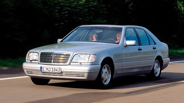 Silver metallic 1991 Mercedes-Benz S-Class driving on a public road