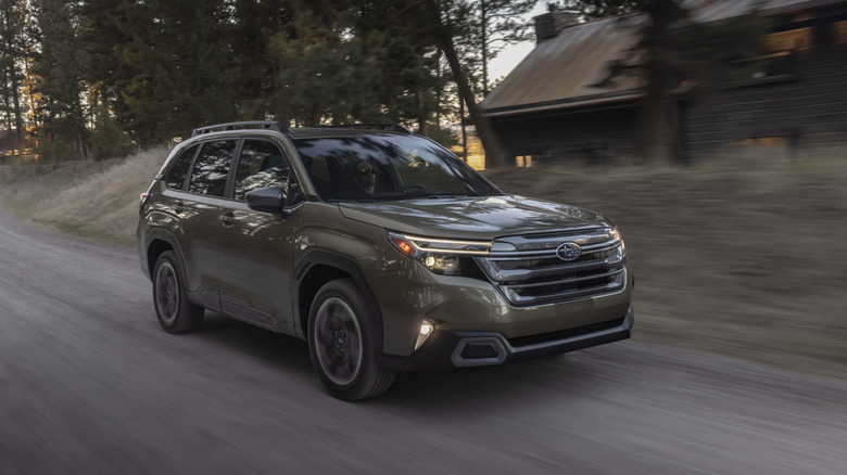 2025 Subaru Forester driving at speed on dirt road front 3/4 view