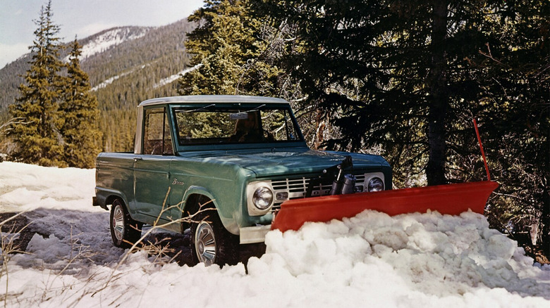 A Ford Bronco Pickup shoveling snow