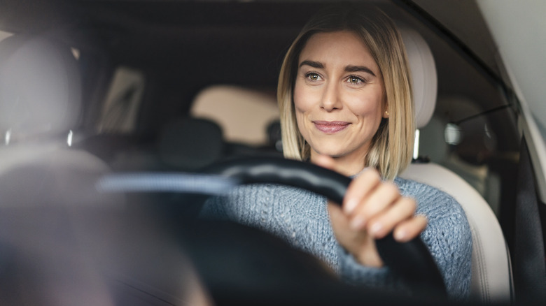 Woman driving while smiling