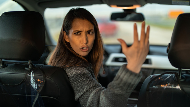 Angry driver swearing at car behind her