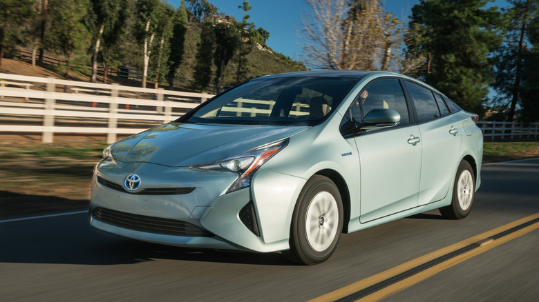 Toyota Prius 4th Gen Pre-Facelift driving at speed front 3/4 view