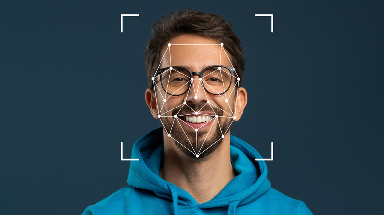 A person with face recognition algorithms working on them