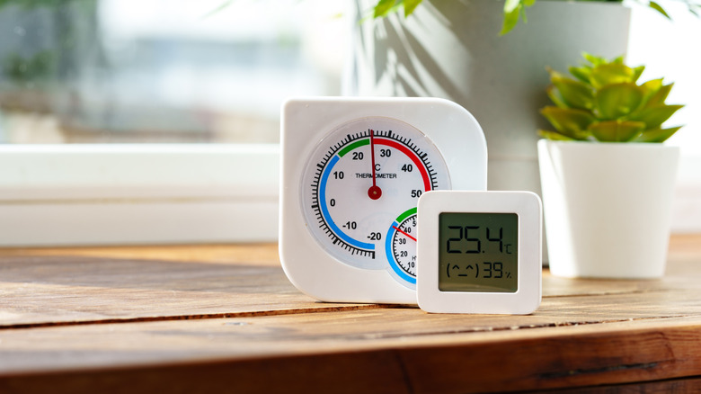 A digital thermometer and a humidity sensor kept on a table