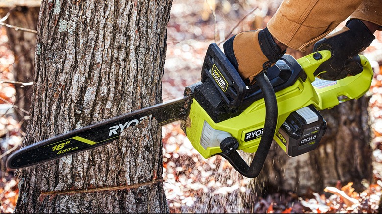 cutting a tree with Ryobi chainsaw