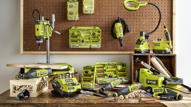 Assortment of green power tools arranged on a workbench