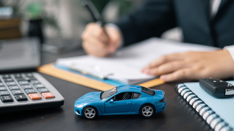 signing documents to buy a car