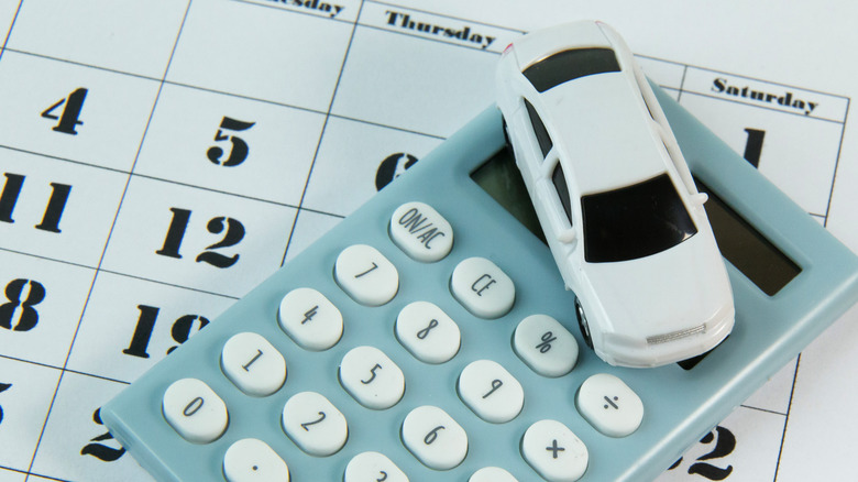 toy car and calculator sitting on calendar