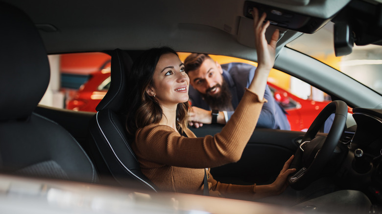 woman exploring the inside of a car