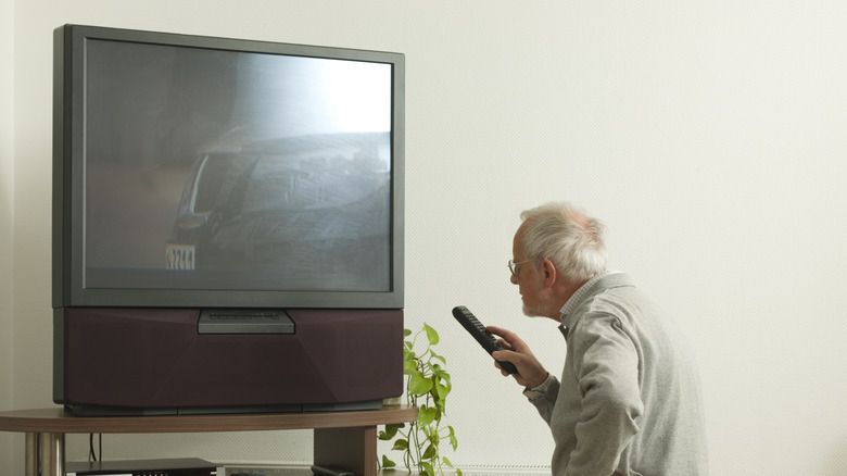 Old man using old TV