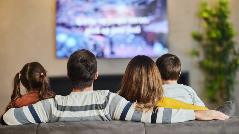 Family watching television together