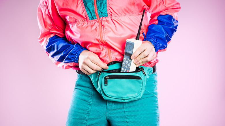 Man putting vintage phone in fanny pack