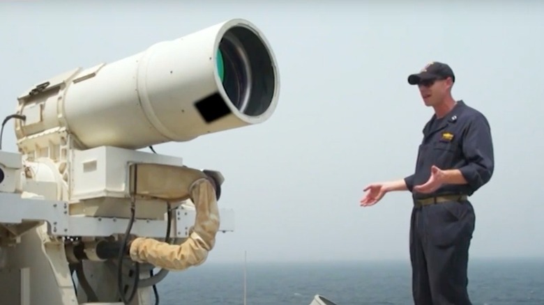 man demonstrating laser weapon