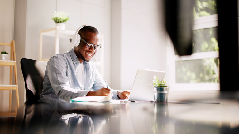 Man working at desk wearing headphones