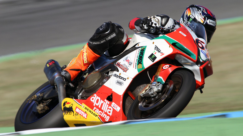 motorcyclist on an Aprilia RSV Mille riding around a racetrack