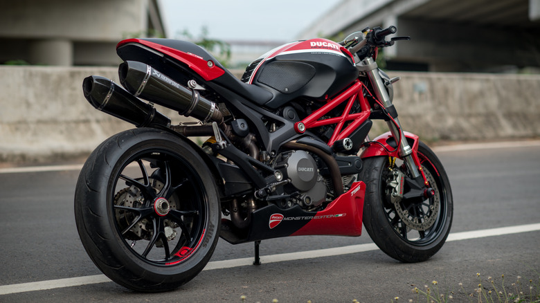 black and red Ducati Monster 796 parked on a road