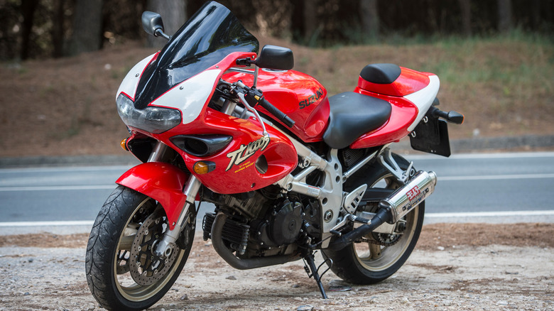 red and black Suzuki TL1000S parked on dirt