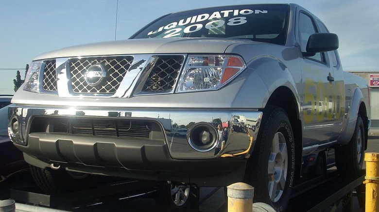 2008 Nissan Frontier with a sales sticker