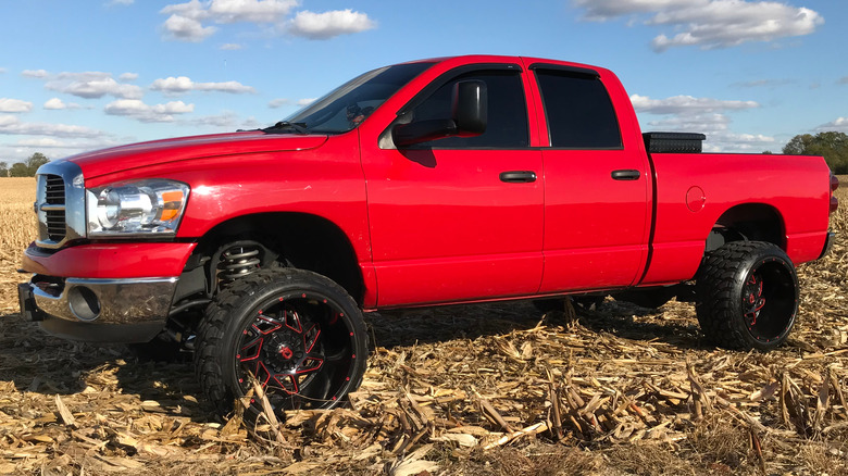 Red Dodge Ram 2500 parked in a field