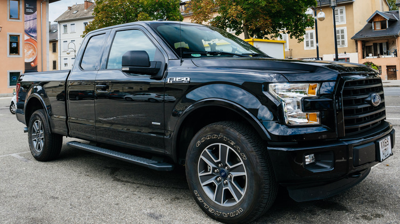 A black Ford F-150 in a parking lot