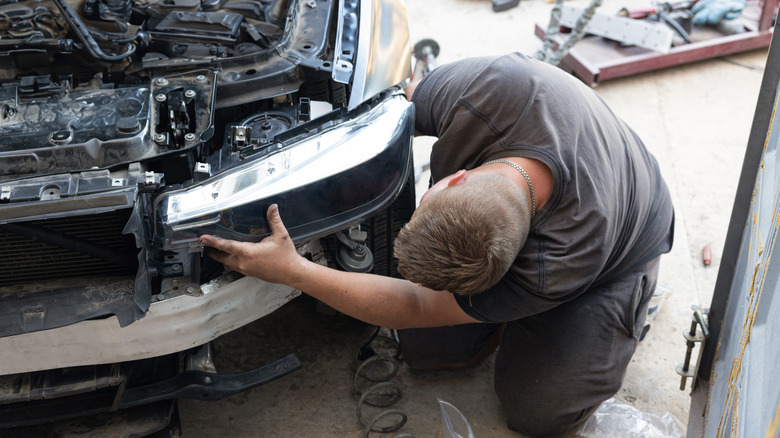 Person working on a headlight