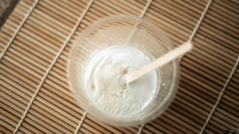 A plastic cup holding baking soda