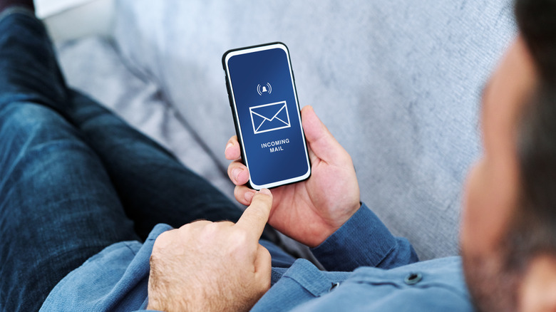 man holding phone incoming mail