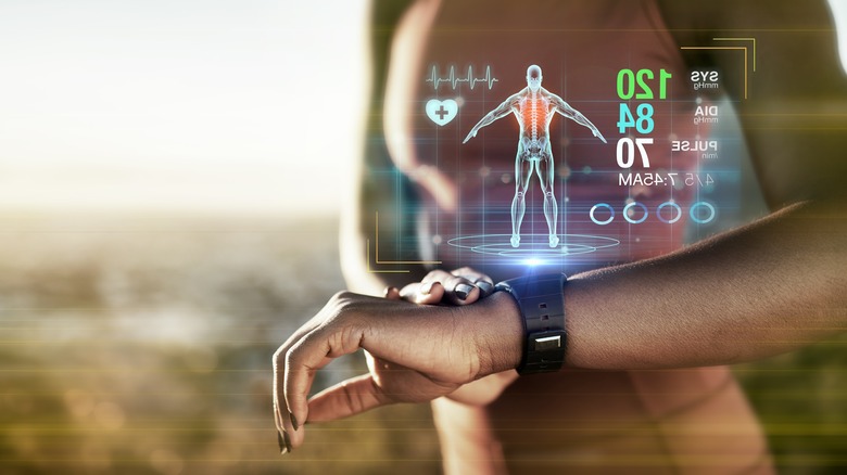 woman holding watch hologram health data