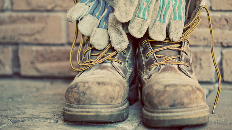 A pair of work boots and work gloves