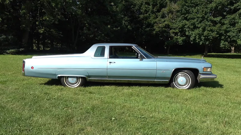 Light blue cadillac mirage in field