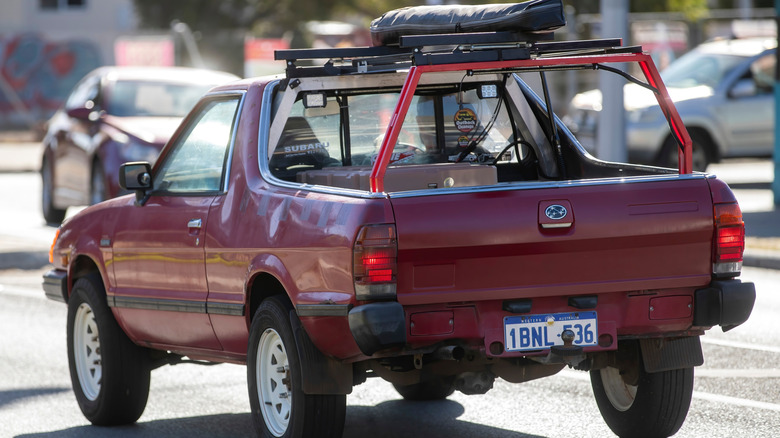 Maroon subaru brat on road