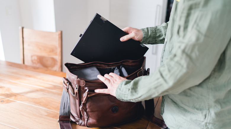 Person taking laptop out of bag