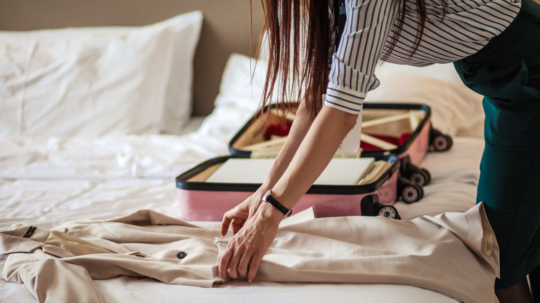 Woman packing suitcase