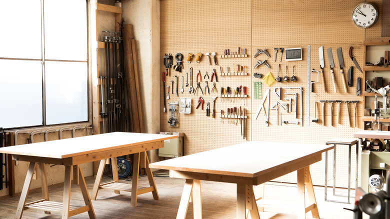 a workshop with hand tools on the wall