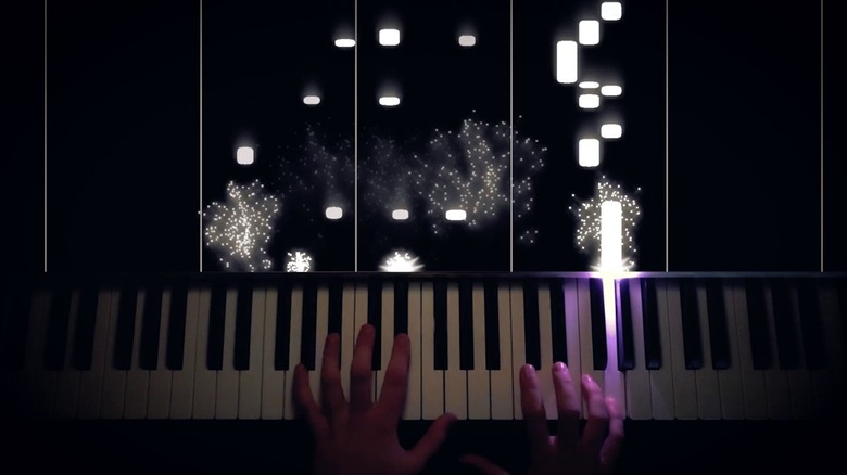 Person playing piano with Pi Zero LED piano visualizer