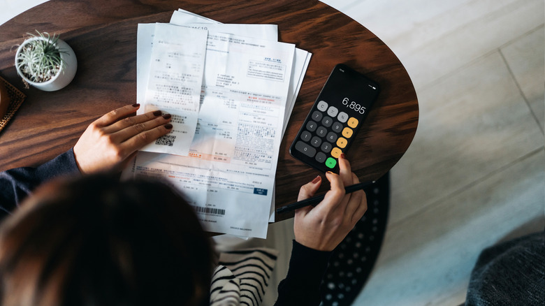 Overhead shot of person calculating expenses