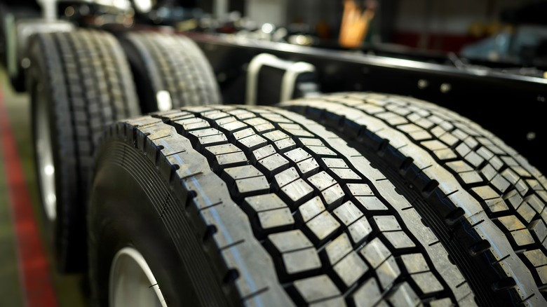 Four brand new tires in a garage