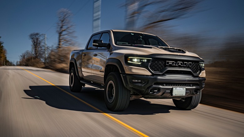 A 2023 RAM 1500 TRX driving on a country road