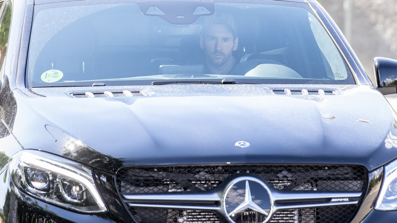 Lionel Messi driving a Mercedes-AMG SUV