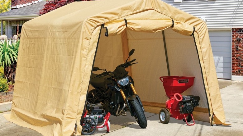 Large shed with a motorcycle and power equipment inside