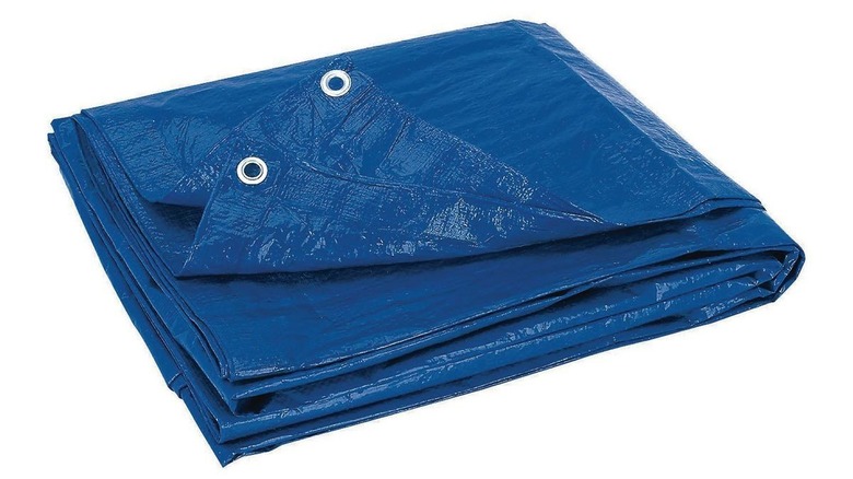 Folded shiny blue tarp with two silver grommet holes