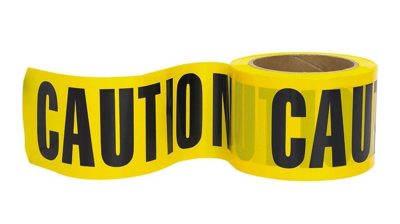 Ribbon of yellow tape with the word caution in black letters