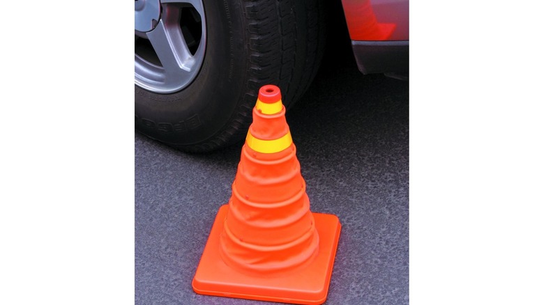 orange safety cone with a small yellow ring at the top and a larger yellow ring below