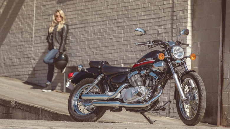 Rider standing behind Yamaha V Star 250