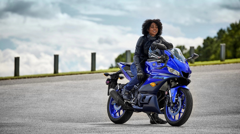 Person sitting on a blue Yamaha YZF-R3